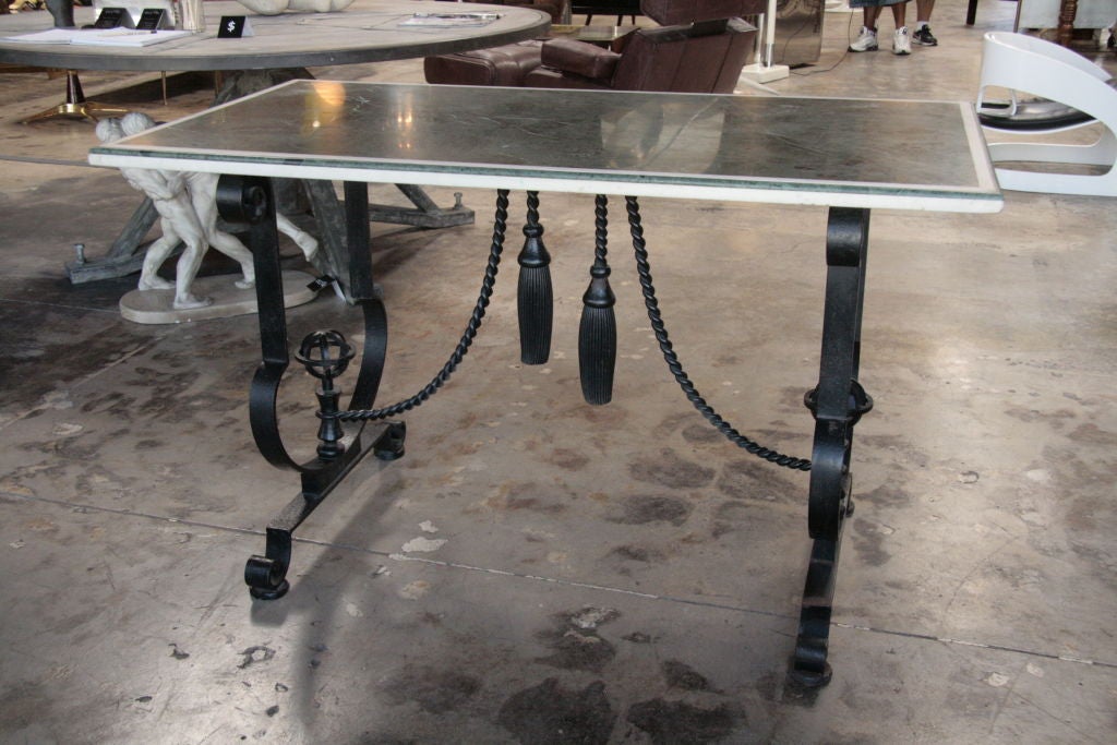 Iron, marble, tassels, what more could you ask for in this unusual table. One of a kind!
Attribution: Gilbert Poillerat.
