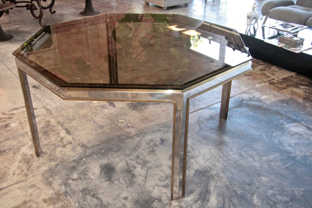 Octagonal 70s swinging style table in chromed steel and brass with smoked glass top.
Have we left anything out? Only that it's original.