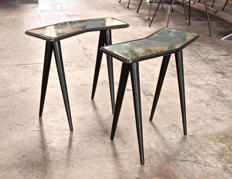 Pair of chevron-shaped end table in ebonized wood with mirrored glass top.
Featured in 