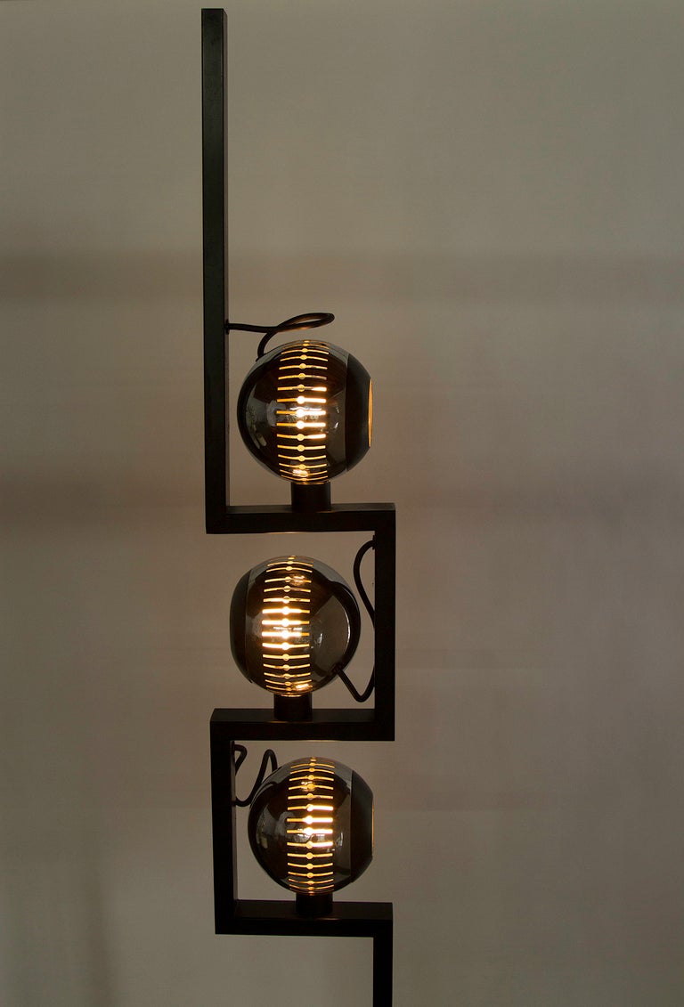 Three globe floor lamp by Arredoluce change description to read: Floor lamp with three chrome-plated perforated steel magnetic globes that adjust to various positions. Original cord. Each globe takes one E27 60w maximum bulb. Metal stem and marble