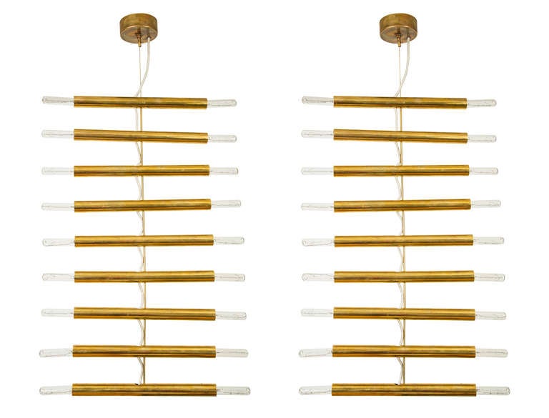 Two Brass 9 Cylinder Chandeliers that Pivot into Various Shapes.