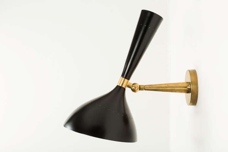 Pair of black and brass sconces with up and down light.