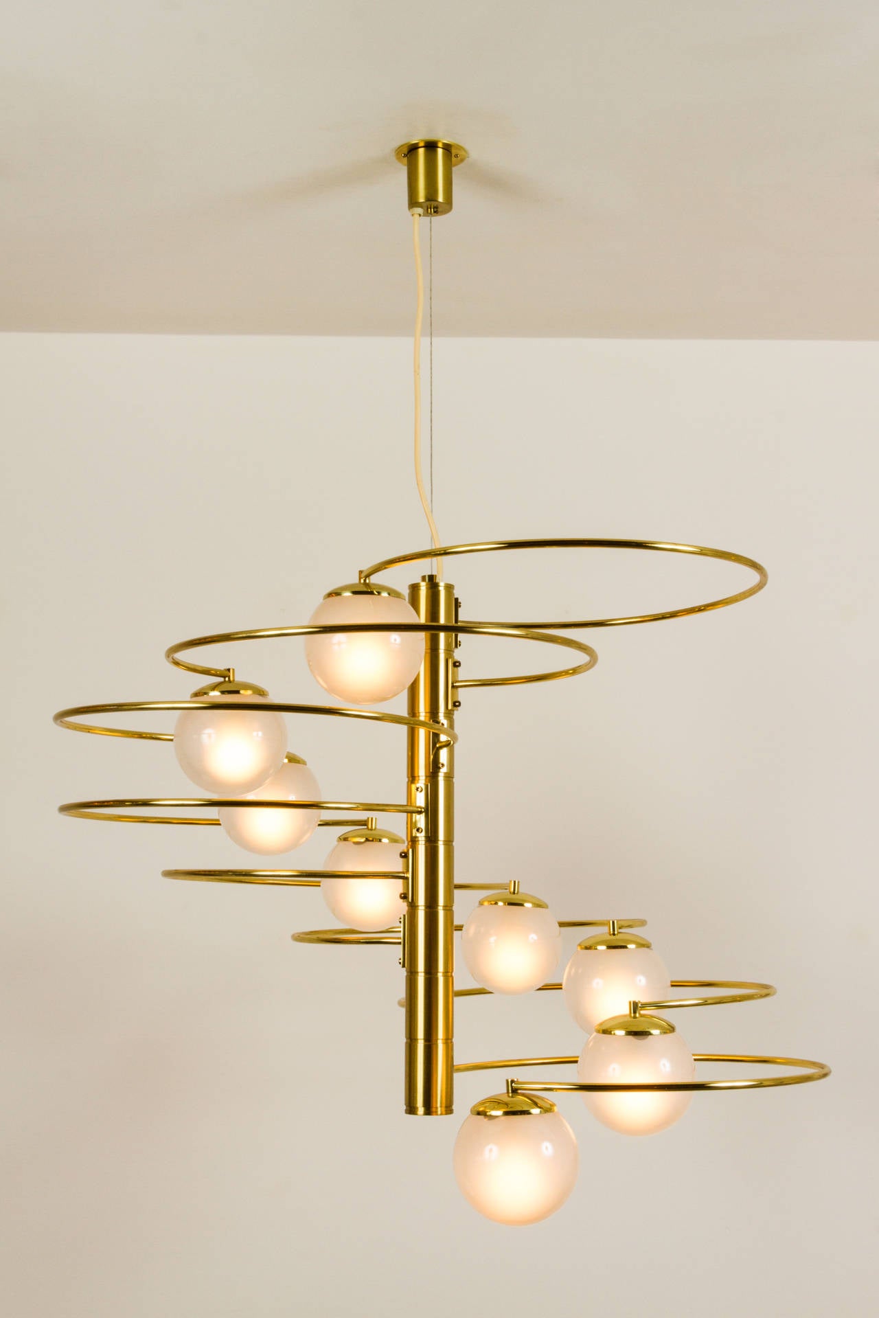 Brass eight-arm chandelier,
Translucent, grey glass globes.