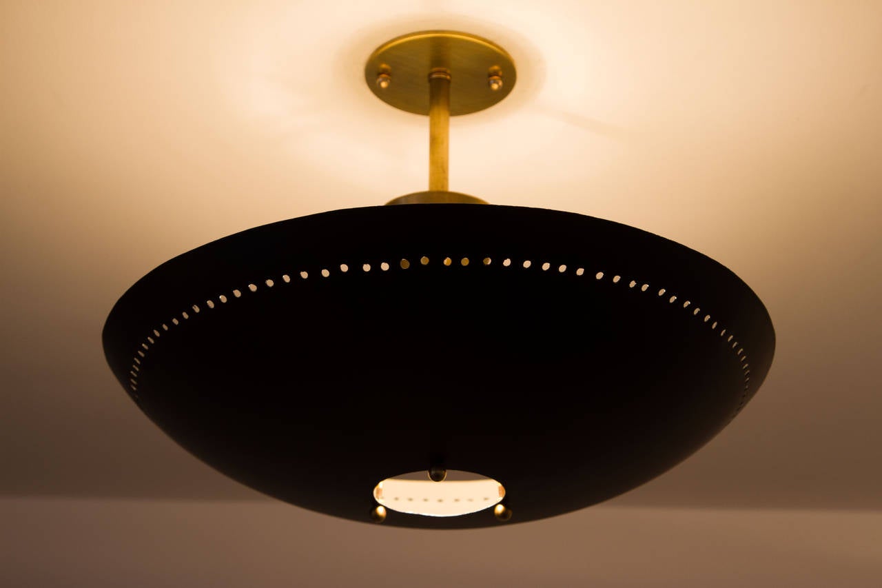 Perforated flush mount ceiling light in the style of Stilnovo.