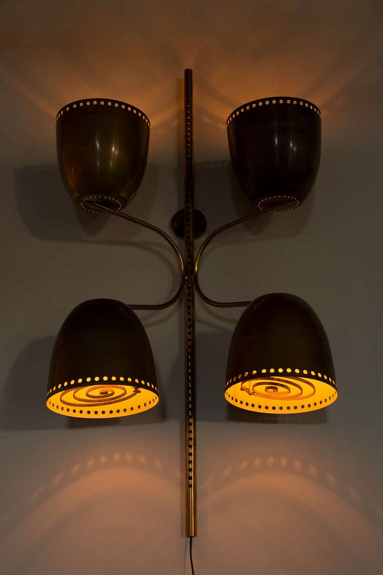 Two Brass Wall Lamps with center bar to adjust shade height
Perforated edge and Brass filaments on the inside of the shades 
Wired with two way switches, on French twist cord
Vintage Restaurant Lights
