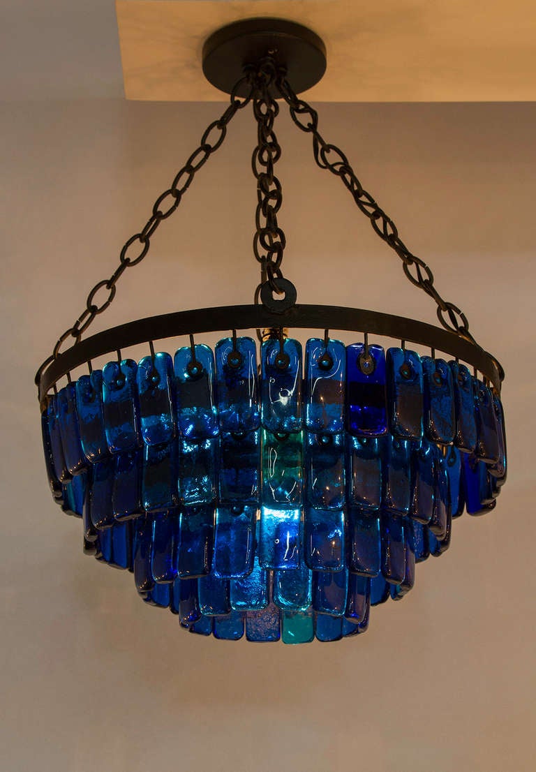 Cascading heavy glass chandelier mounted on iron frame