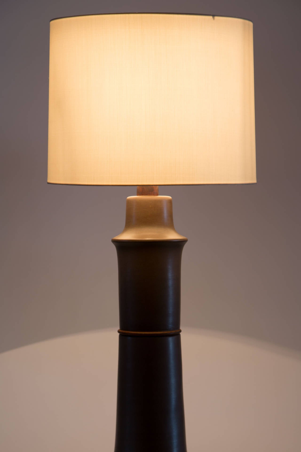 Large ceramic table lamp with teak neck.