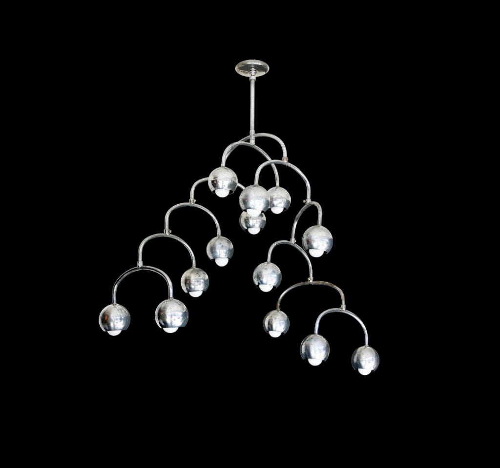 Chandelier with adjustable arms to form various positions resembling a mobile
