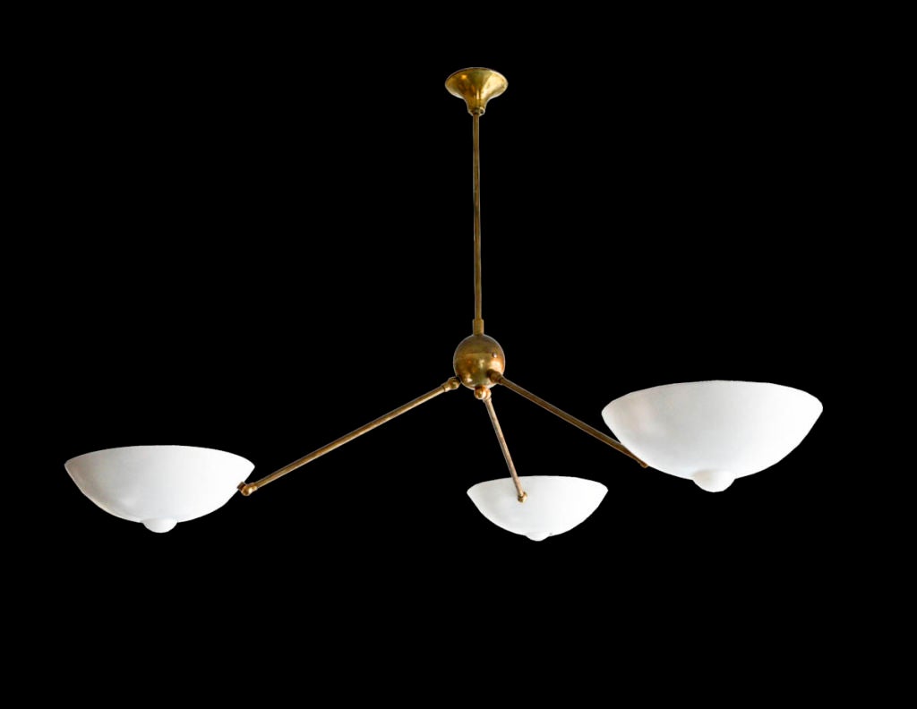 Three arm chandelier. Each arm is mounted on a swivel for adjustment as we as the shades