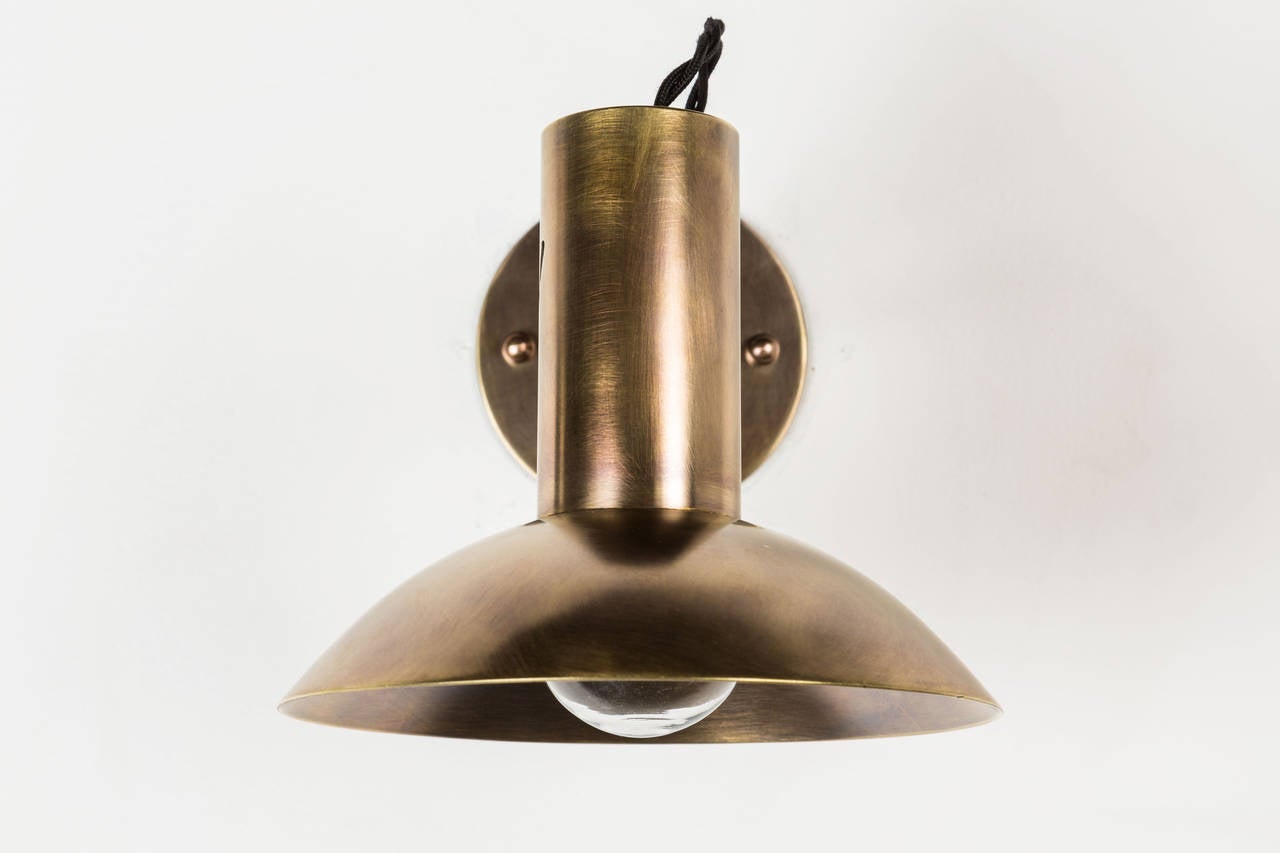 Brass sconces with articulating shades.