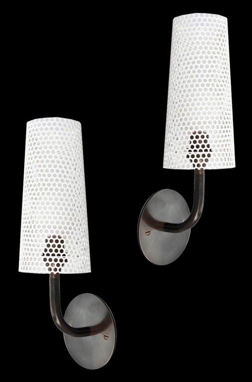 Rewire custom perforated sconces. Available in white black or selection of RAL colors. Each sconce takes one E26 100w maximum bulb. PRICED AND SOLD INDIVIDUALLY.
