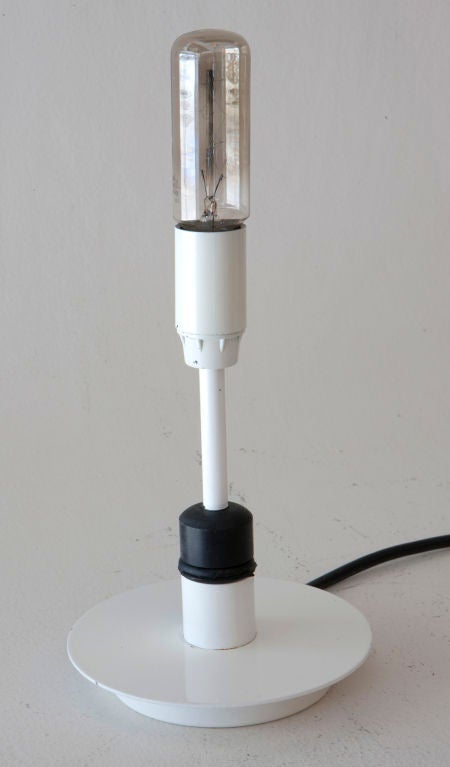 Minimalist table lamp with adjustable shade.