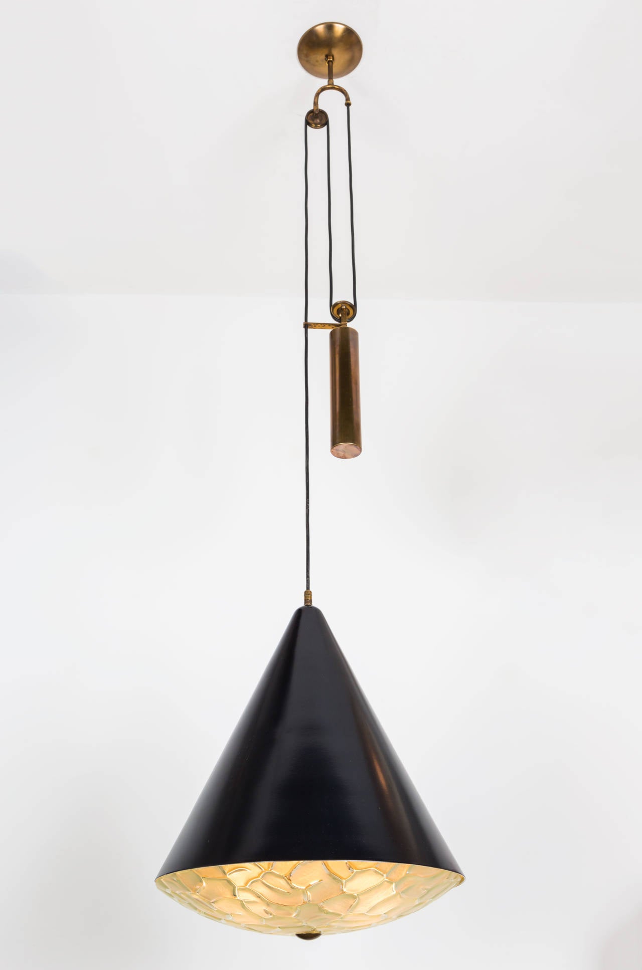 Painted metal and textured glass pendant with brass pulley.