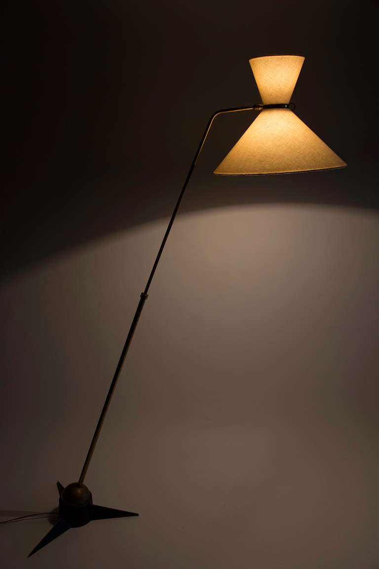 Floor lamp with brass ball attached to star base.  Arm rotates on ball in any desired location.  Arm extends up and down to desired height.  Shade is mounted to pivot joint for lamp direction, with a lamp in both top and bottom shade.
