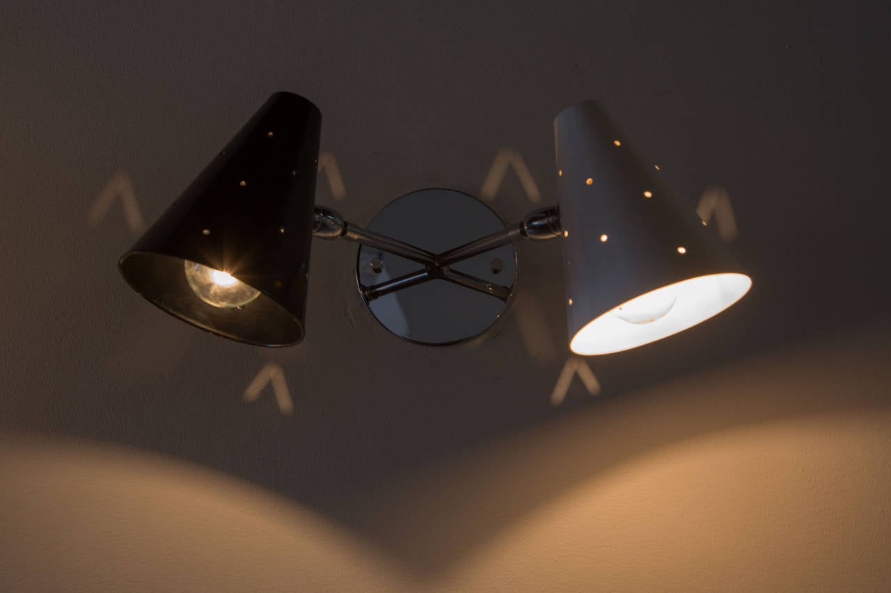 Double shade pivoting ball joint sconces, perforated shades.