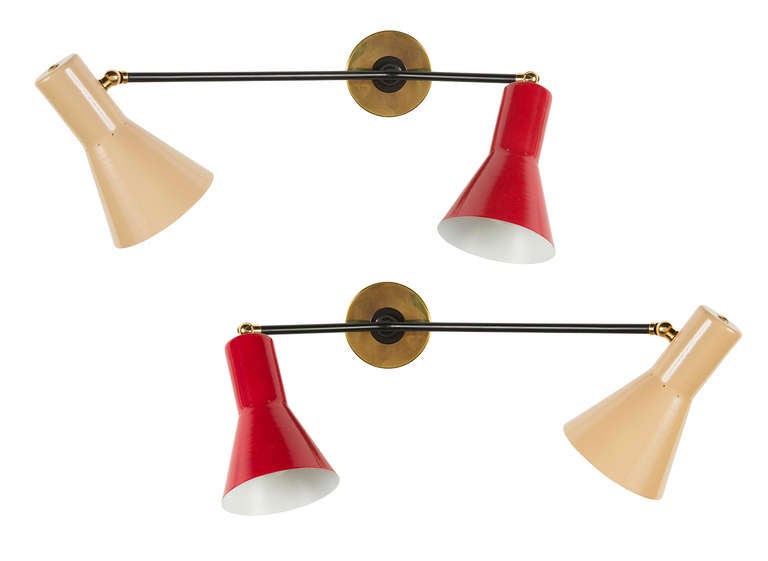 Pair of asymmetrical sconces with pivoting shades