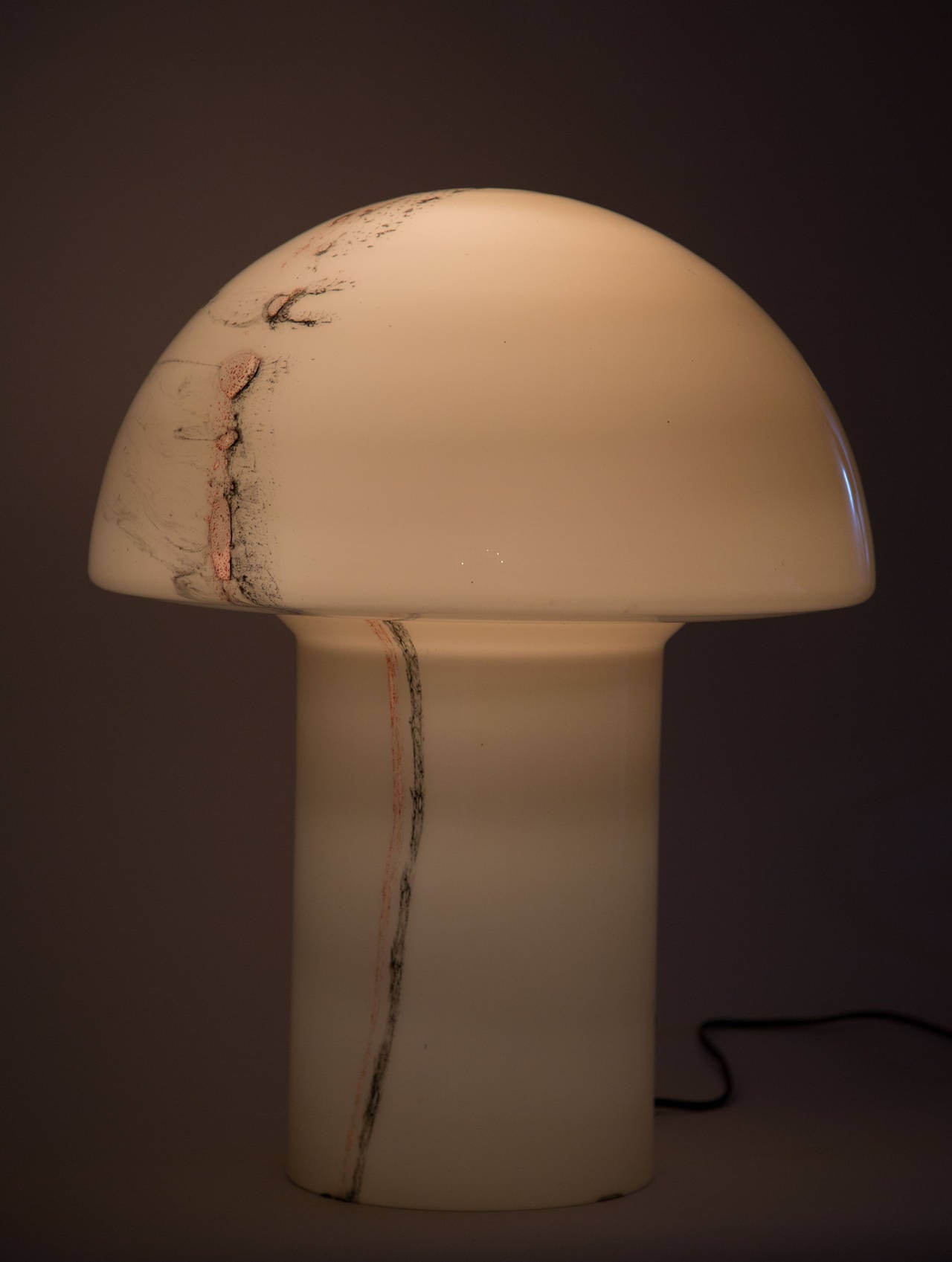 Mushroom lamp in smoke glass with details of black and orange.
