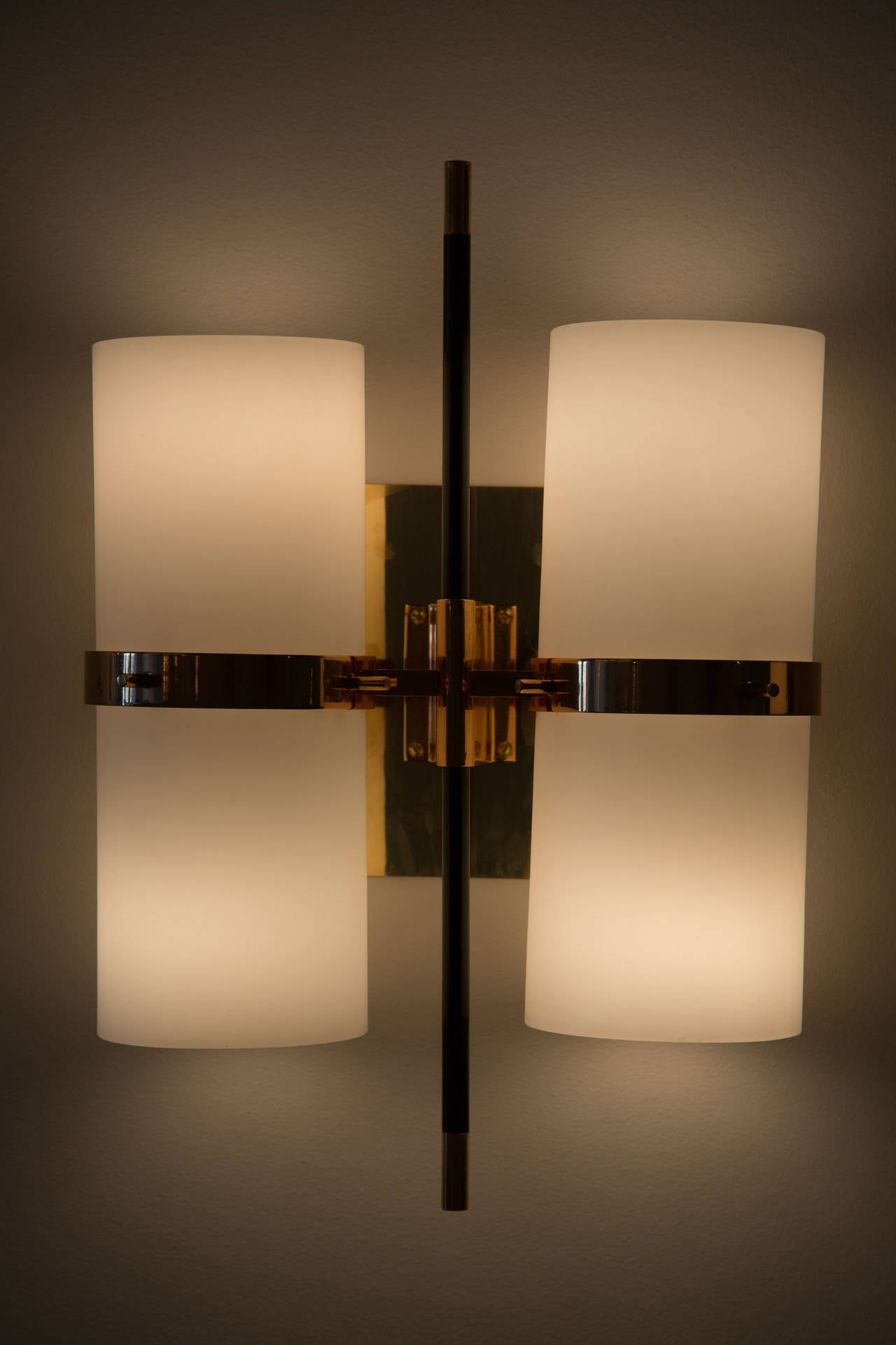 Brass and satin glass double shade sconces.