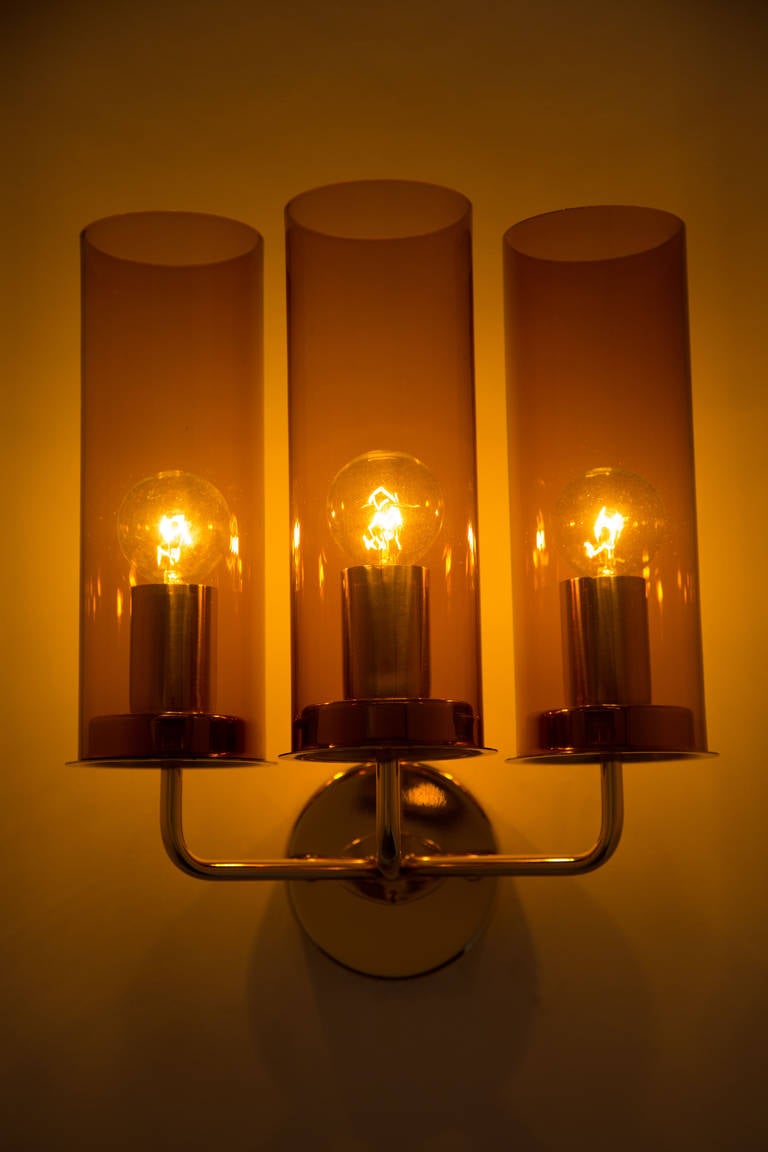 Pair of amber glass and brass sconces.