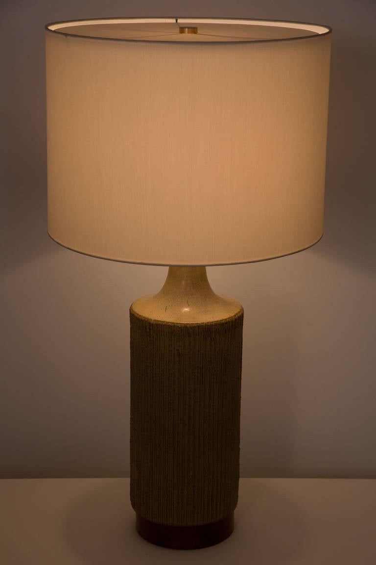 Textured ceramic table lamp with
walnut base.
