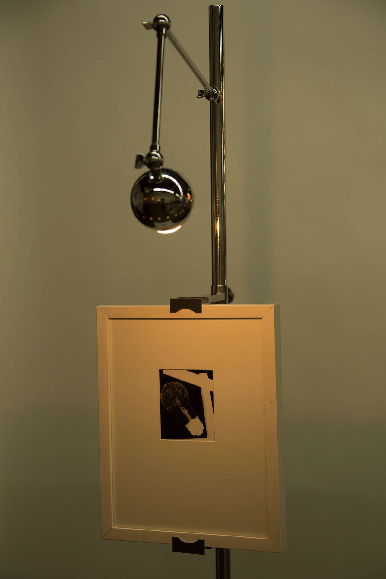 Easel Floor Light by Angelo Lelli for Arredoluce designed and manufactured in Italy circa 1960's. Chrome plated brass, pivoting  shade, with adjustable arm for displaying artwork, marble base. Original cord. Takes one E27 60w maximum bulb