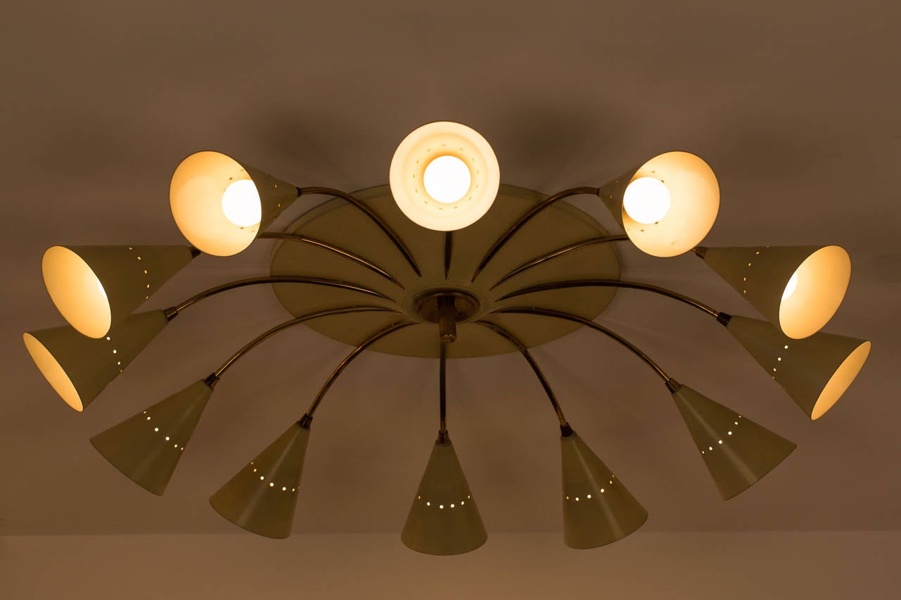 Twelve Arm Chandelier by Stilnovo. Manufactured in Italy circa 1950's. Rewired for US junction boxes. Takes 12 E14 European candelabra 15w maximum bulbs
