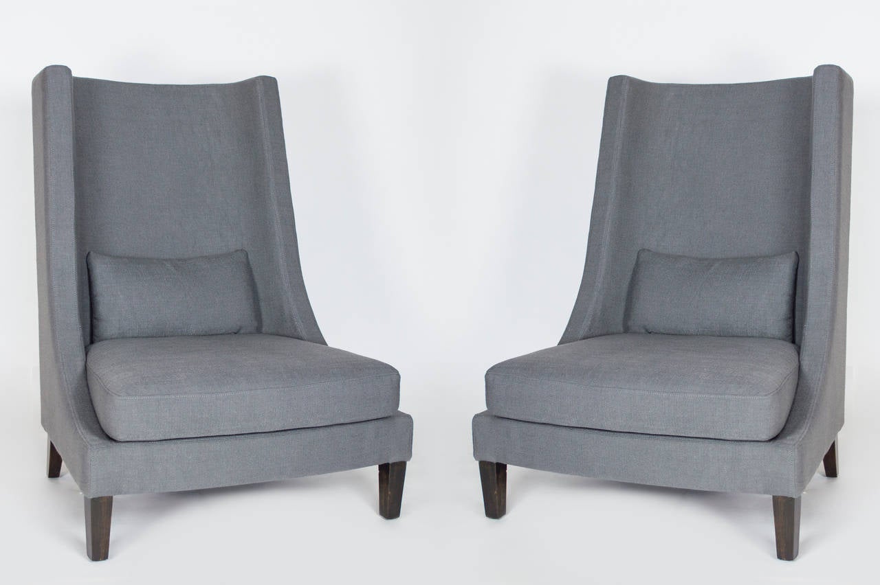 Elegant design with modern lines. A unique take on the
classic wing back chair.  Charcoal Linen upholstery.