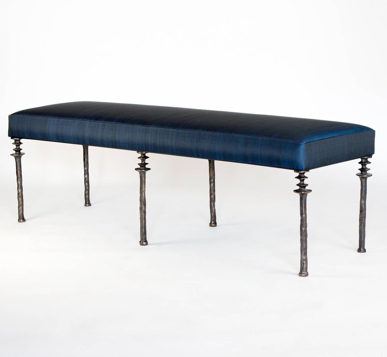 Insipred by Diego Giacometti, this bench is ideal for those who are looking
for unique seating. Their cast bronze legs provide a truely organic touch.  The cushion is upholstered in blue woven horse hair fabric.  Bench is located in our showroom in