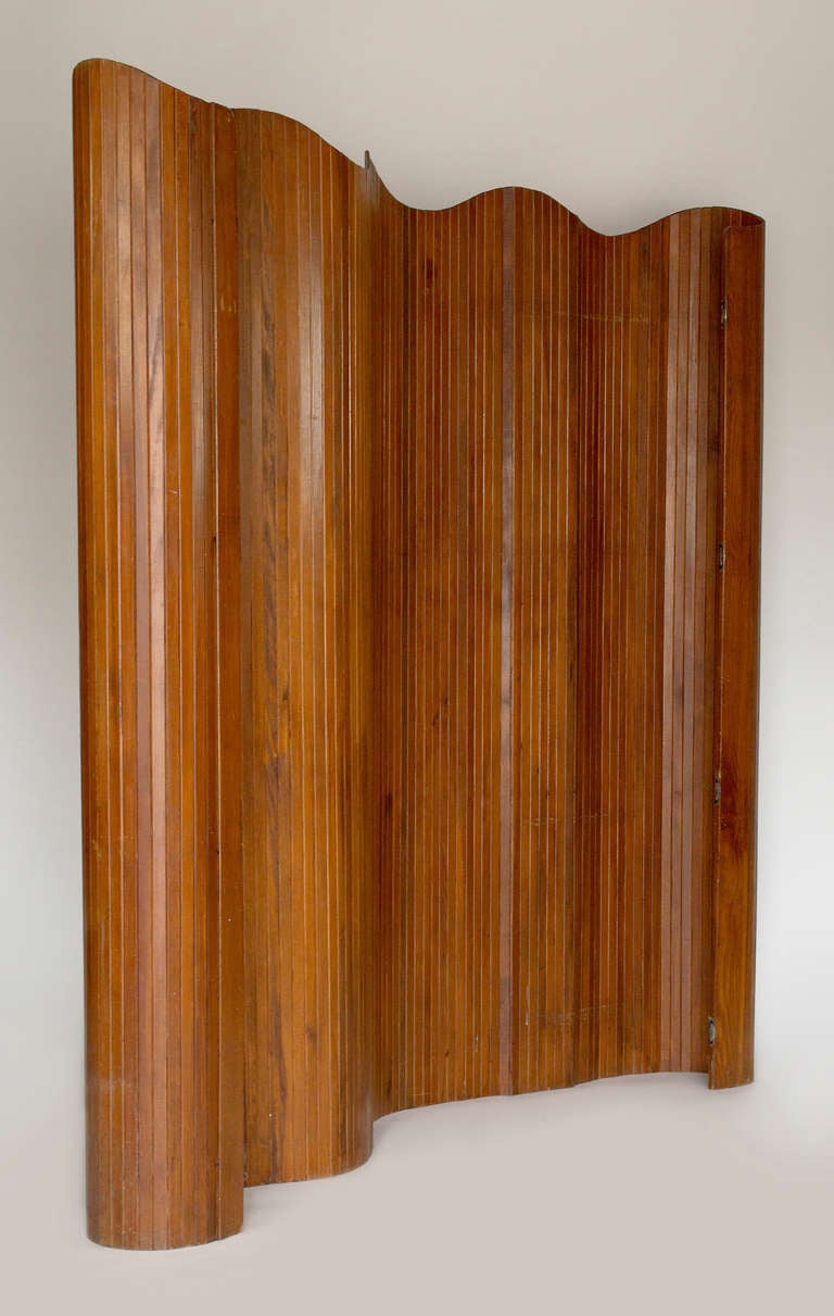 By Duremail, Toulouse France,   Circa 1950.  This screen made from rattan provides for a excellent room divider.  It is light weight and the flexible design allows for great versatility.  The warm wood tone blends well with all decor.