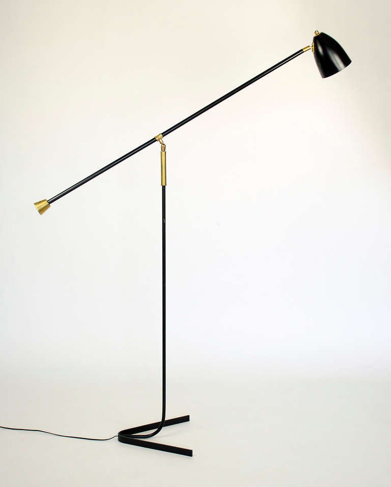 Rare Counter balance floor lamp by Guariche,  Black enamel finsh with brass accents.