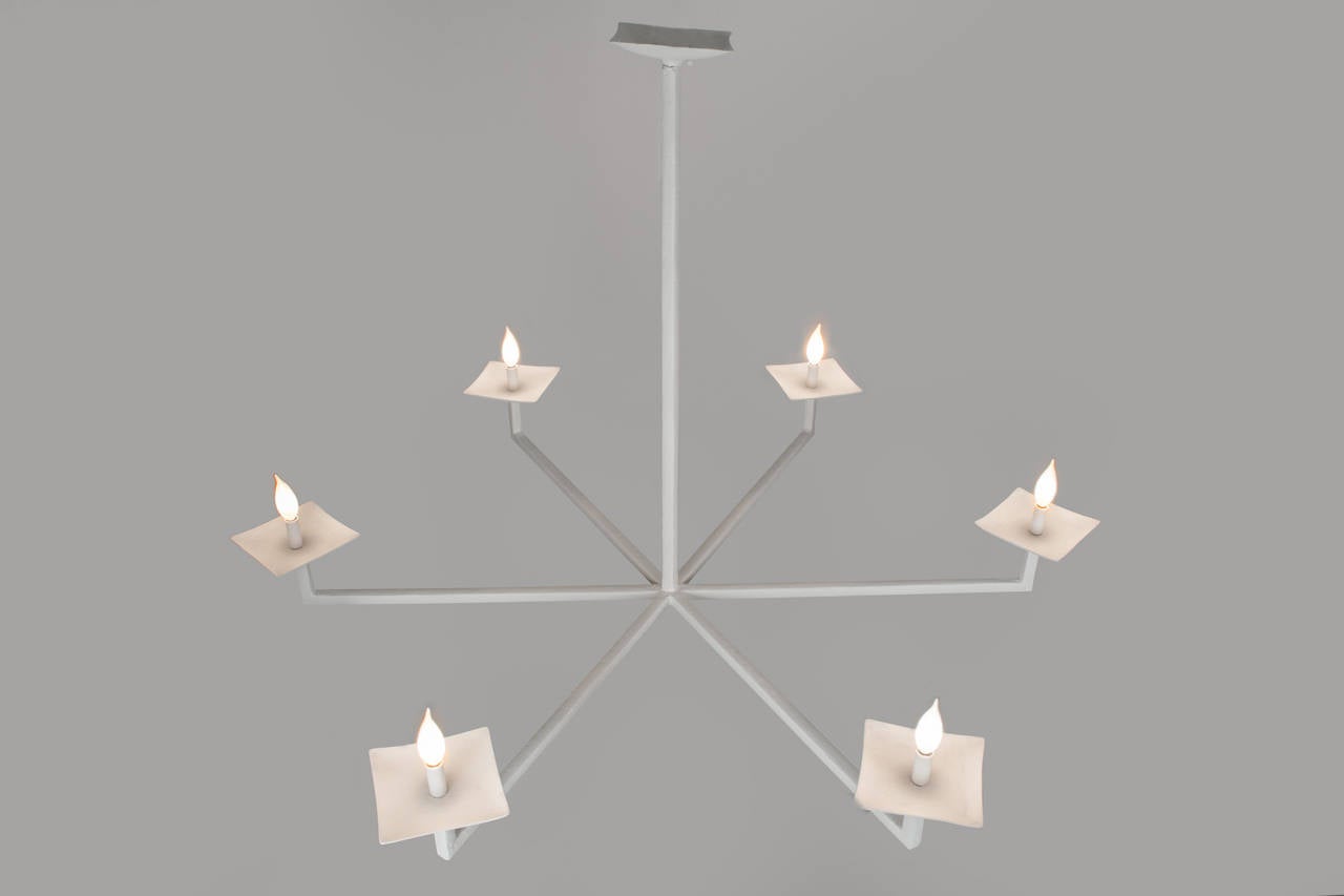 This version of our popular chandelier, with a square framework instead of round, goes well in all décor schemes from modern to traditional. It is a twist on the classic candleholder design. It provides enough light to be the centerpiece of a