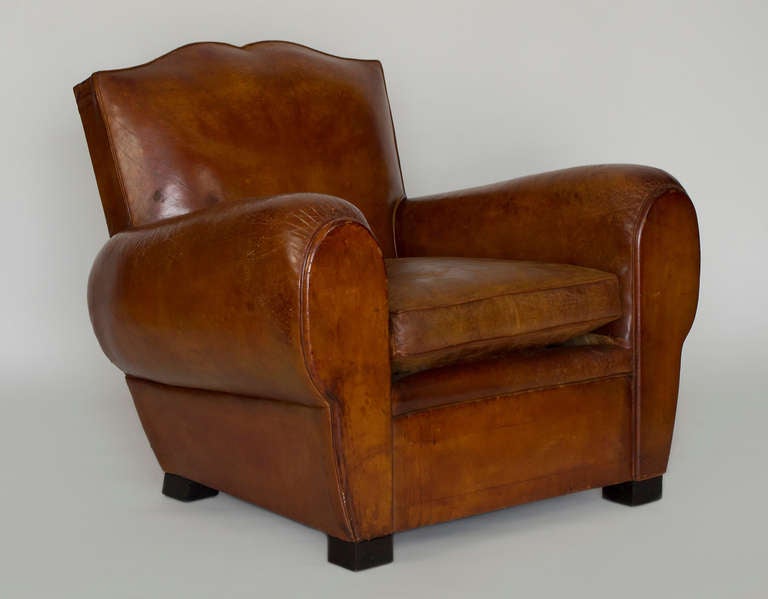 This club with its mustache design is in perfect condition.  It has been expertly restored and is a solid chair with a great patina with its leather in perfect condition.  The cushion has had a new down and foam insert. There are now breaks or