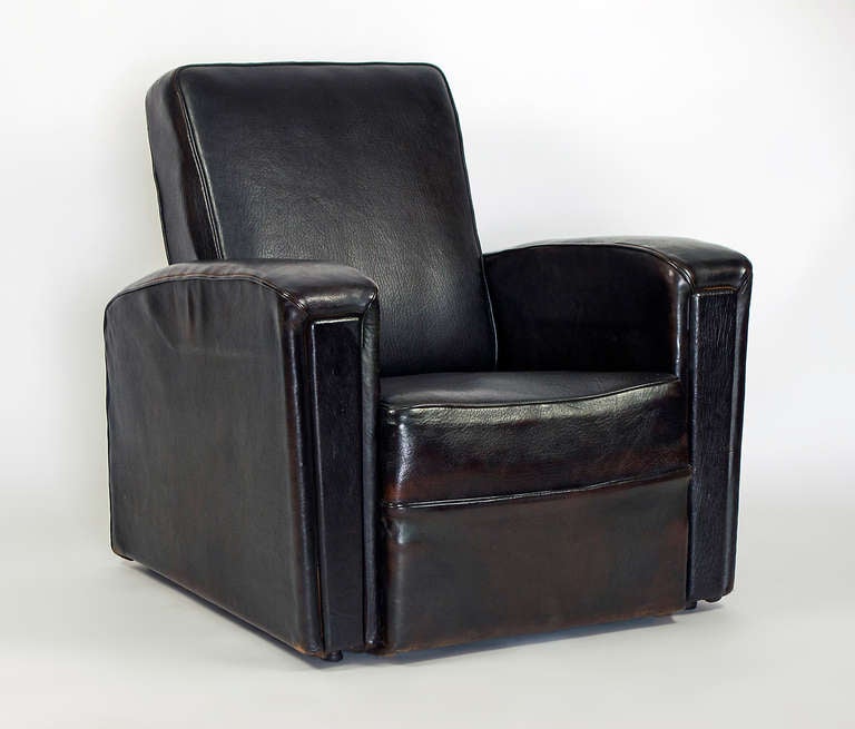 Two leather covered arm chairs built by Airborne. These chairs are built in the 1950 with a steel frame.  The leather is in perfect condition, and has been stained to an elegant dark chocolate color.  Very comfortable, yet they are not oversized