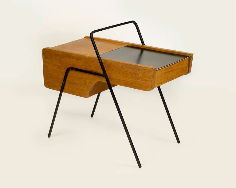 Oak and steel small side table which is part of a series of wall-mounted furniture. The designer has created a unique line of furniture with angular and curving lines. Table ingeniously opens providing ample compartmentalize storage. We have other