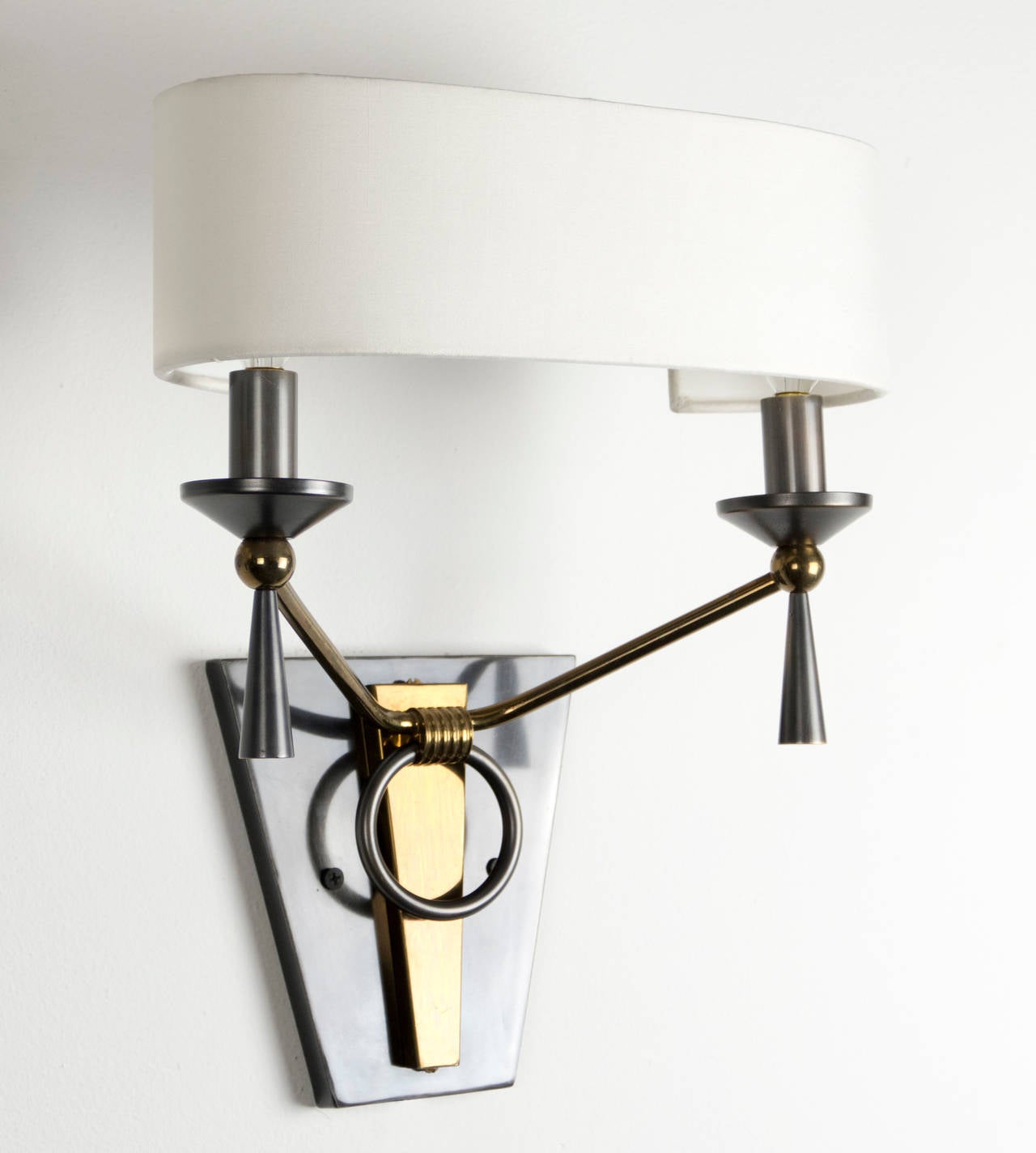 Beautiful set of four Sconces by Maison Arlus. They are crafted from brass and steel.New White silk oval shades. 2 candelabra based bulbs per light,  Max wattage 40 each.