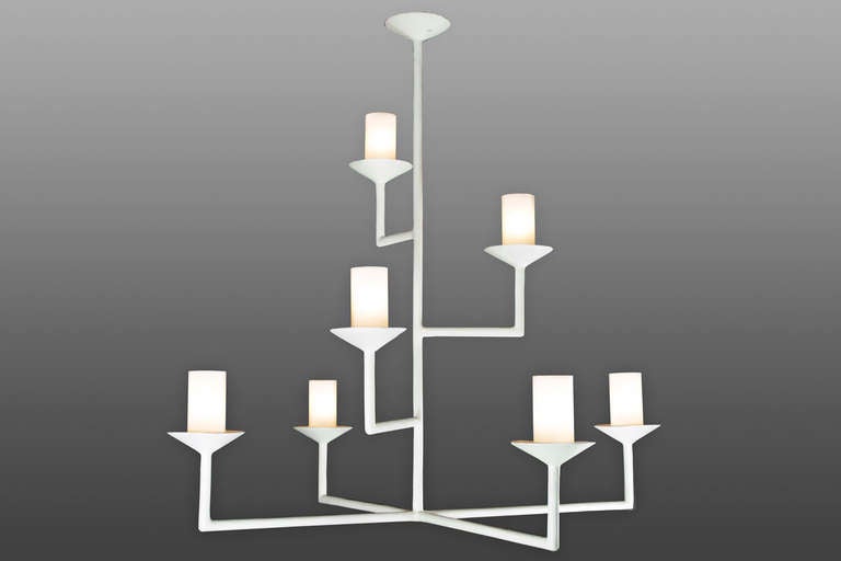 Seven-arm chandelier with a plaster of paris finish. Glass tubes with white and clear fret conceal the light bulbs. 

Light uses seven candelabra based bulbs. Max wattage 60 watts each.