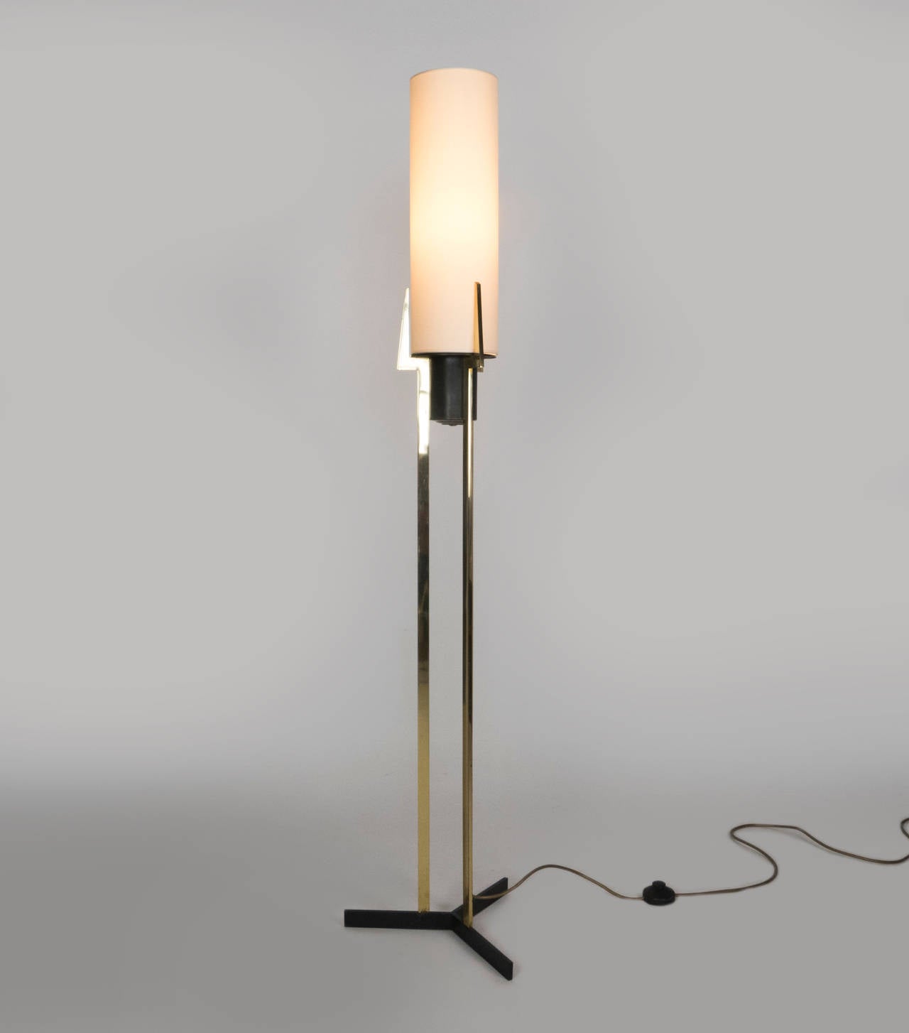 Mid-Century brass tripod floor lamp. A new Linen tube shade sits a top the brass and steel frame. The fixture has one medium based bulb. Max wattage 60 watts. new wiring. The shade dimensions are 18