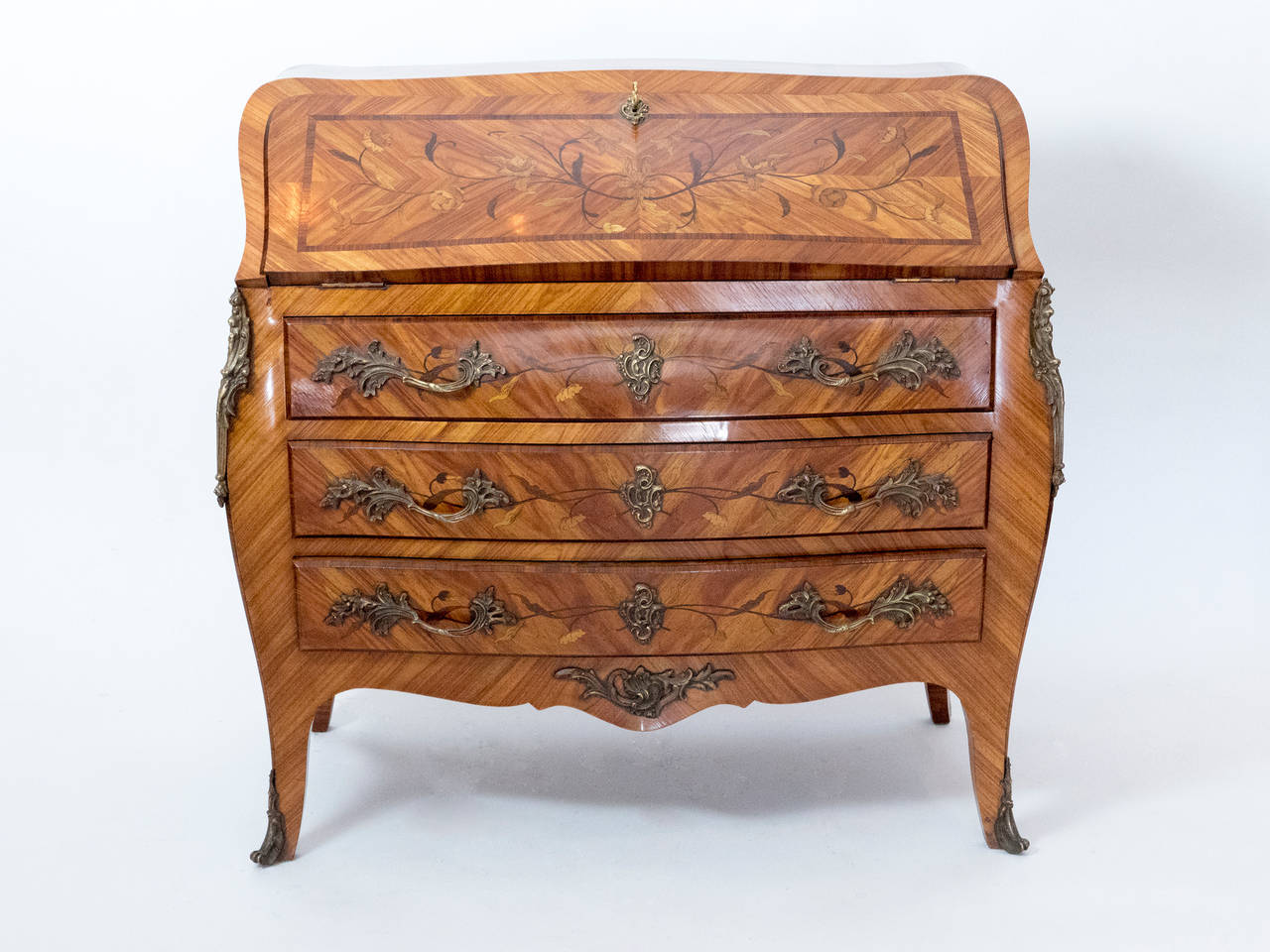 An incredible 19th century Louis XV style secretary with ornate marquetry with a floral design and bronze ormolu. The working lock conceals the leather topped work area.  This very elegant piece is in perfect condition for it age.