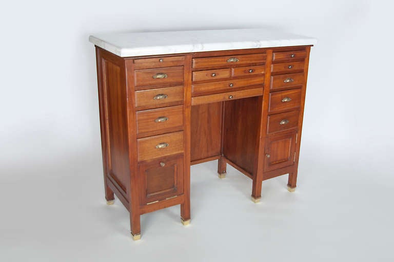 Oak cabinet work station with various drawers and cupboards.  Great craftsmanship and details.  The marble top has been replaced and the unit is in perfect working condition and very clean.  The brass accents add to the charm of the piece.  The back