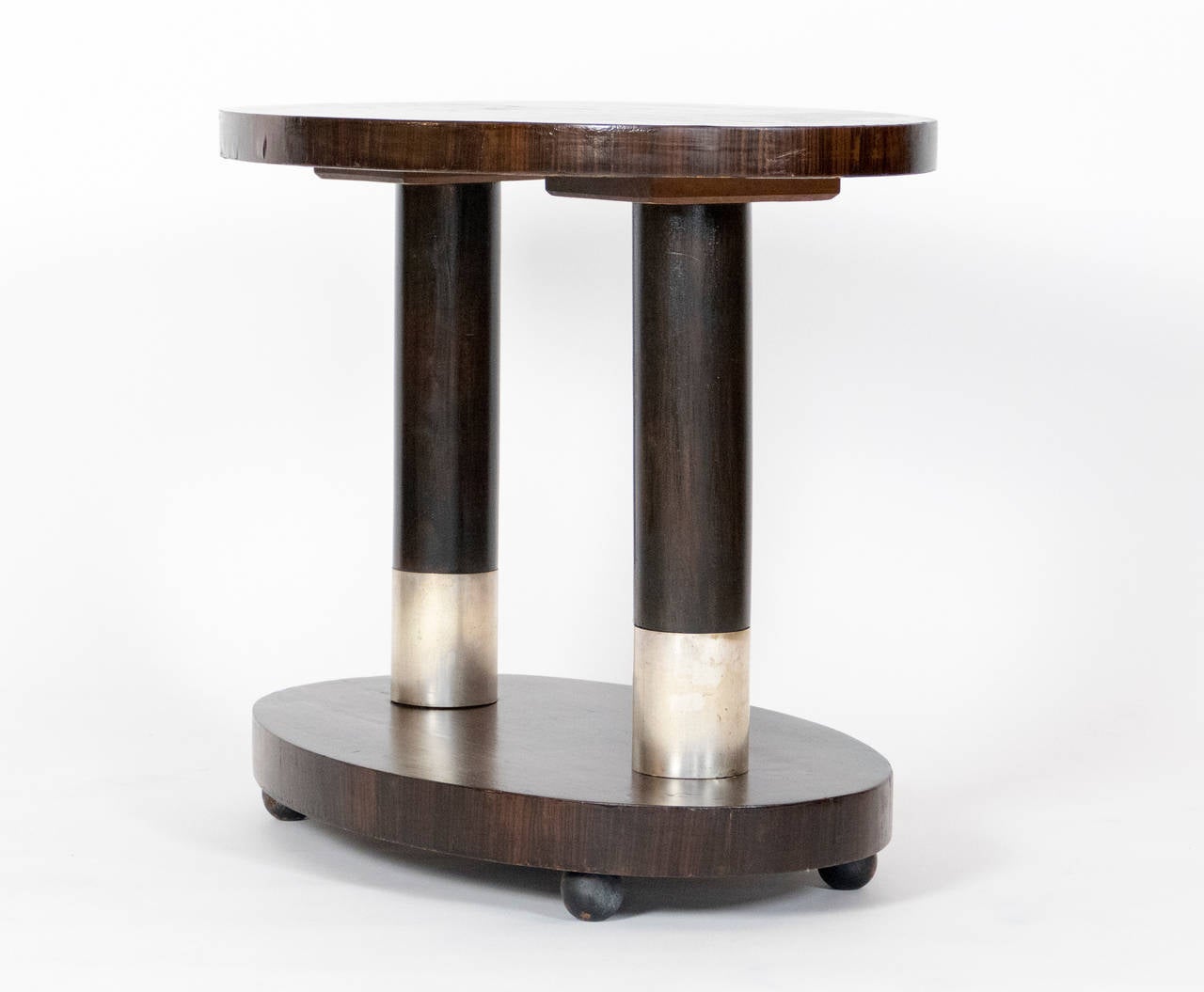 Small scale side table with Aluminum accents and veneered top.