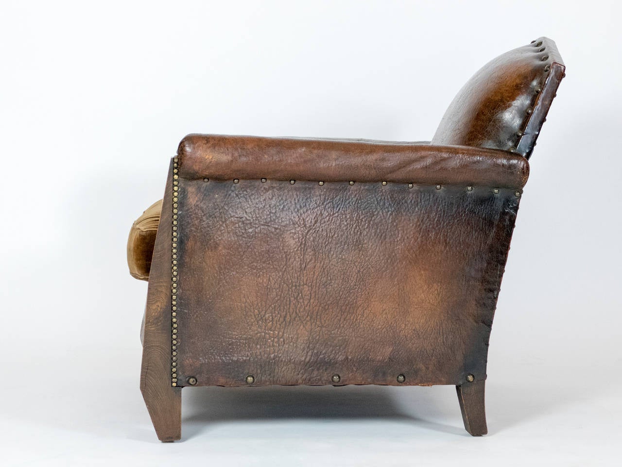 1930s leather club chair in original upholstery.  Excellent condition with beautiful patina.  Solid frame.  The details of the front legs are unique and add a elegance to the frame.  Spring has been reviewed and leather revitalized.