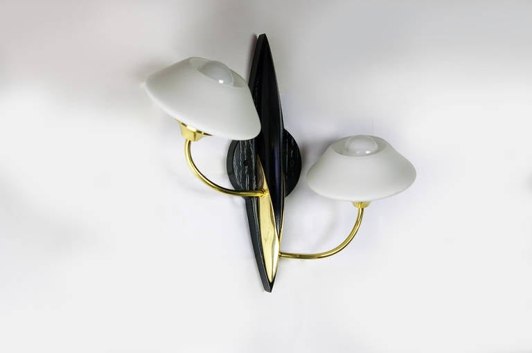 Two gracious wall sconces with opaline glass diffusers. Brass frame on an ebony wall mount. A backplate has been added to fit a standard J box. Sockets have been replaced to an American standard candelabra based socket. Max wattage 60 watts each
