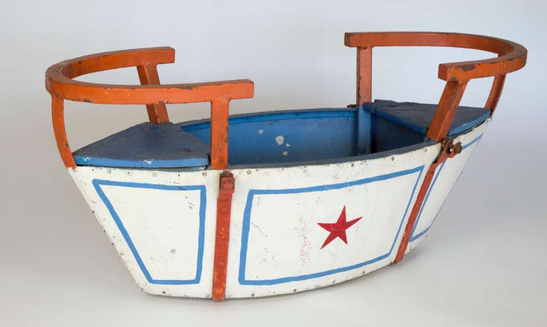 From a Parisienne garden comes this early 1900's swing set seat. The basket hung on chains and provided years of joy for the children of France. This hand-painted boat shape is a distinct decorative item with lots of character. It is perfect as