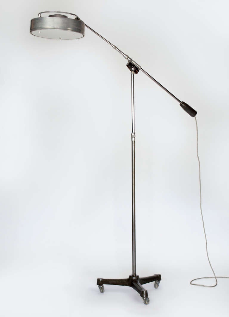 Counter Balance Floor lamp on wheeled base designed by Ferdinand Solere in the 1960's. This industrial light will add a unique touch to your home. Aluminum framed with telescoping elements which permits you to adjust the height and projection.  The