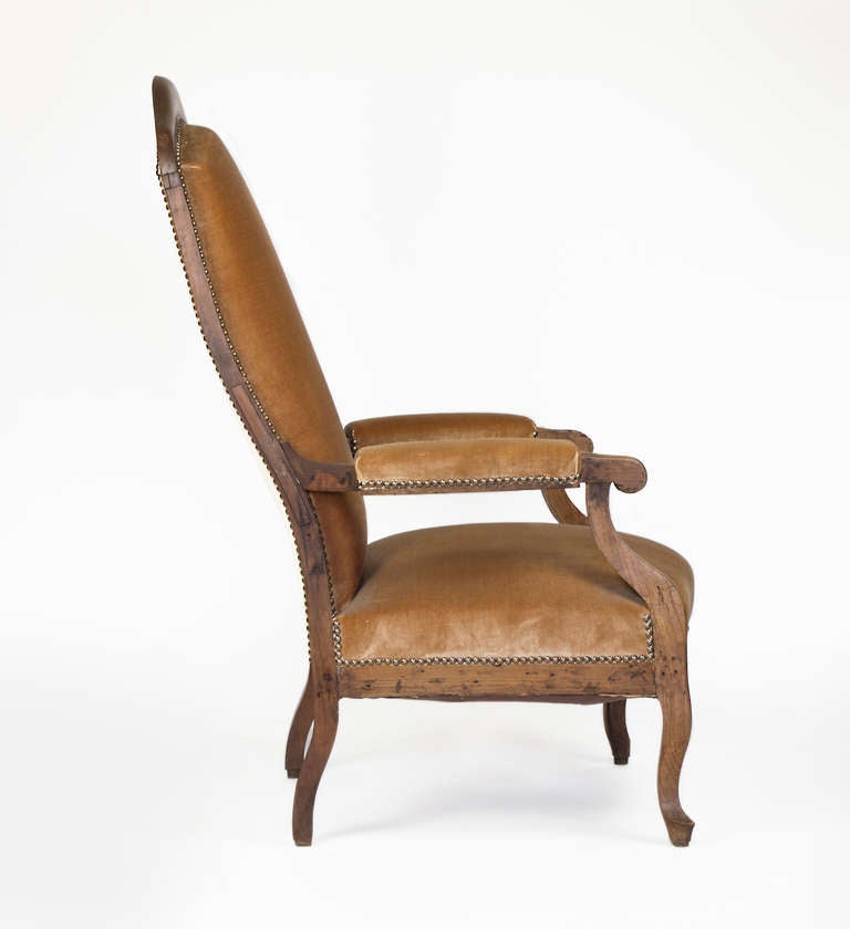 This wonderful arm chair was crafted in the late 19th Century in the South of France.  It has a solid walnut frame.  New mohair upholstery.  It is a classic chair with a sturdy frame.
