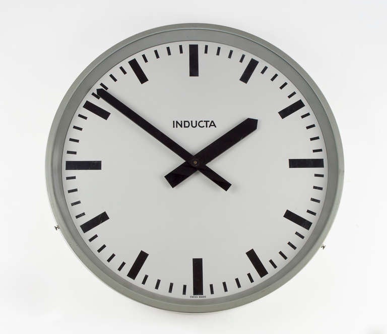 Swiss Made Vintage Inducta Industrial Wall Clock. 
Spun aluminum body with a polychromatic silver/grey finish.    The design is suitable for use with any type of décor.  The clock has a new quartz movement.