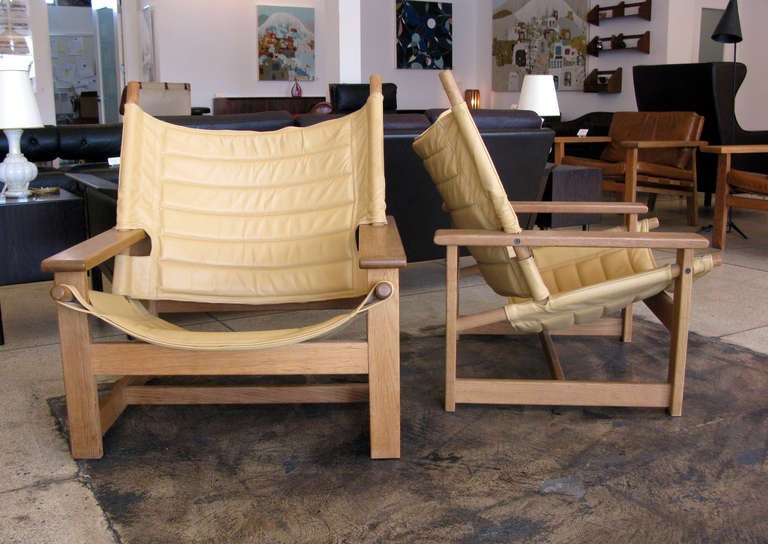 Pair of unique leather & oak lounge chairs.  Blonde oak frames with yellow leather seats.  Seat height measures 12