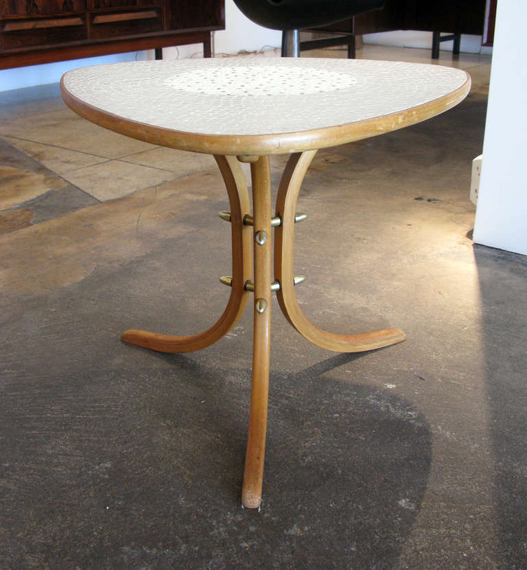 Unique side table with a triangular shaped mosaic tile top, curved wooden legs & brass detailing.