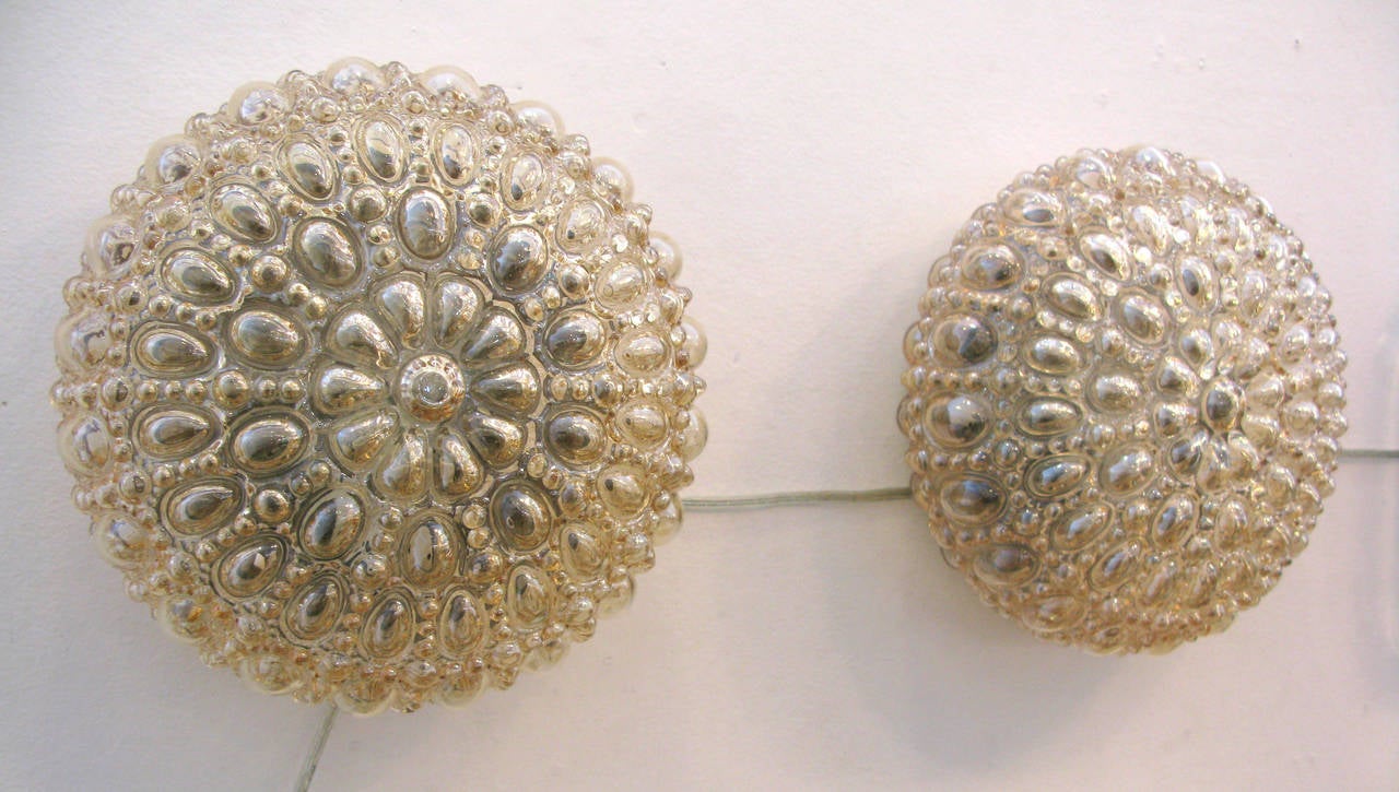 Pair of round amber bubble glass sconces by German glass company Glashüttenwerke Limburg. Matte brass painted back plate.

* ON SALE - originally $2400.  70% off until 12/1/15.