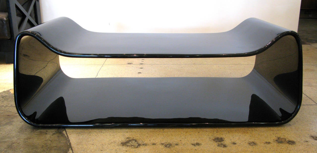 Slope coffee table designed by William Emmerson. Finished in a high gloss black lacquer. Flat table surface measures 13